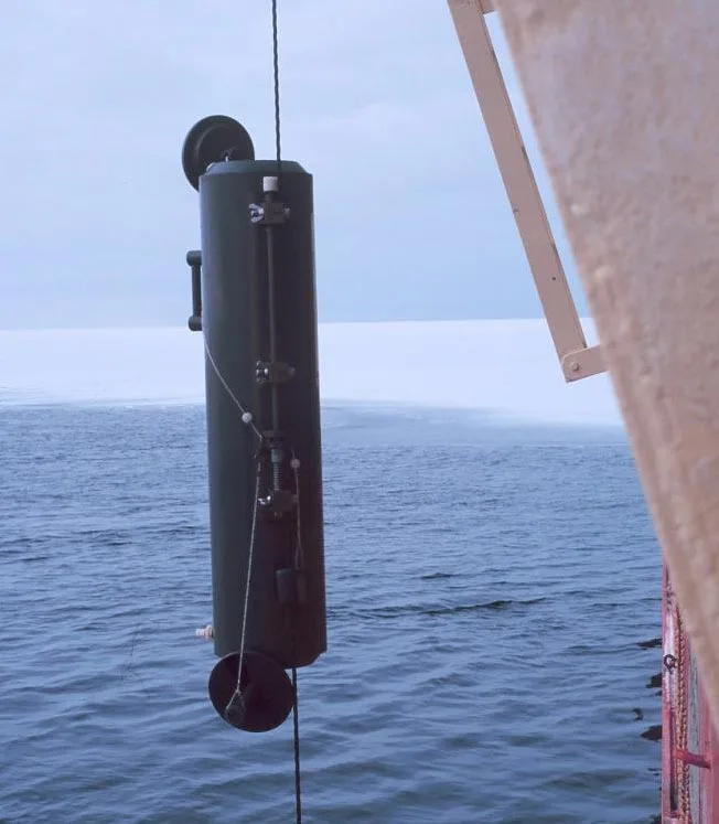A Niskin bottle being lowered into the water for water sample collection