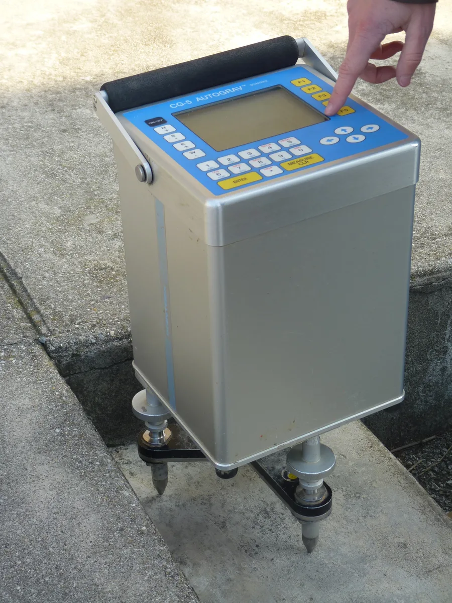 A modern portable spring-based microgravity meter (CG-5 Autograv) set up on its tripod