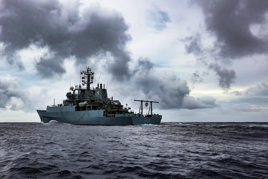A multi-role Royal Navy survey vessel underway, representative of a hull carrying several acoustic and magnetic sensors simultaneously