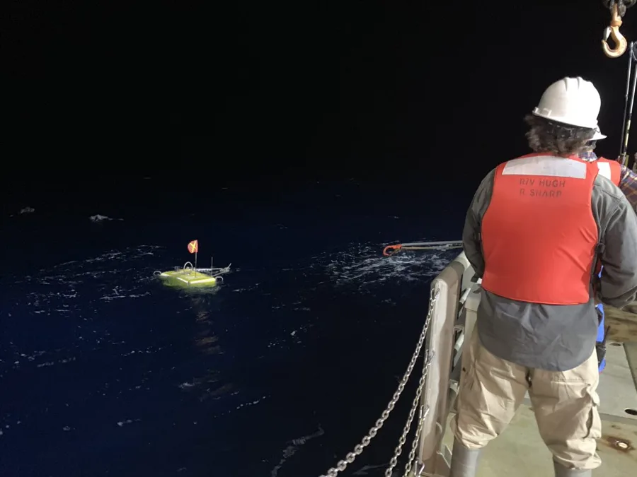 USGS personnel recovering ocean bottom seismometers from a research vessel deck