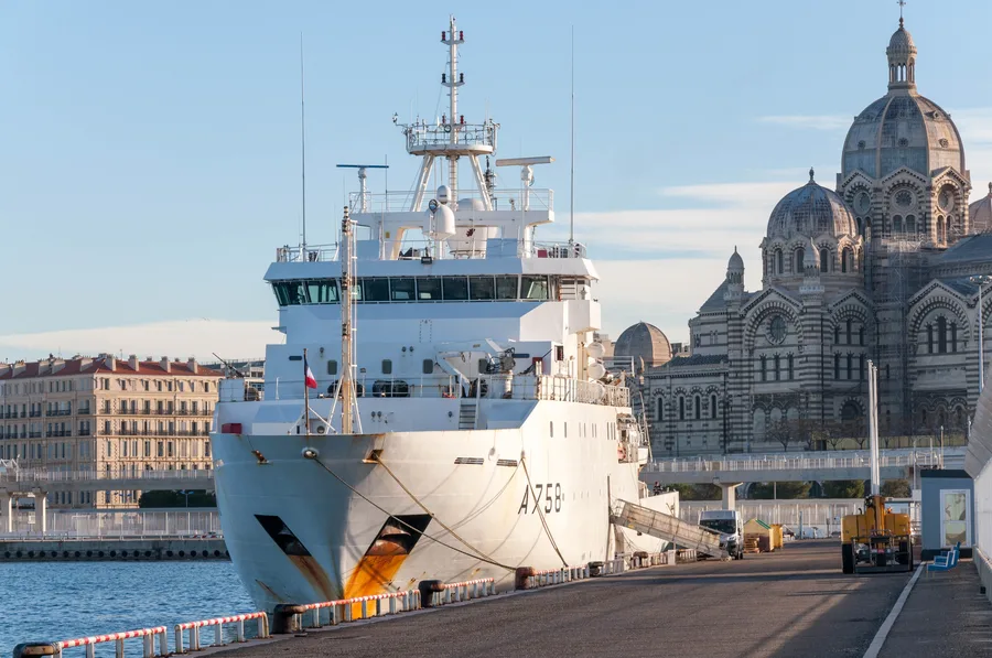 A hydrographic survey vessel moored at dock during mobilization