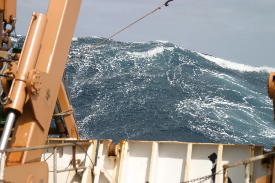 A large wave towering astern of a NOAA research ship in the Atlantic Ocean